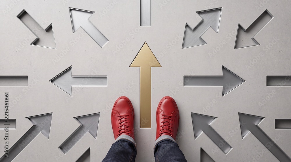 Fototapeta premium Top view of a person wearing red sneakers standing on a gray textured surface with many arrows pointing in various directions, highlighting a central golden arrow for success and leadership.