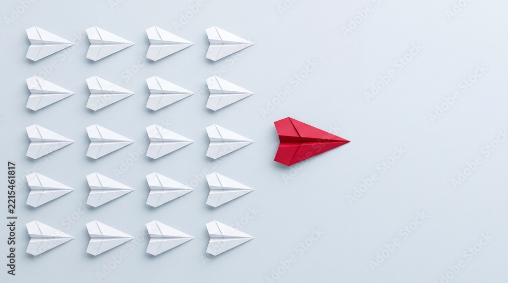 Fototapeta premium Red Paper Airplane Leading a Bulk Group of White Origami Planes in Top Down Overhead View, Symbolic of Leadership, Business Innovation, Standing Out from the Crowd, and Corporate Success