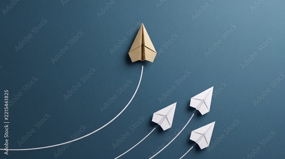 Fototapeta premium Gold Paper Plane Leading White Planes on Blue Background, Top Down Overhead View Representing Leadership, Success, Unique Business Vision, Innovation, and Growth Strategy Concept