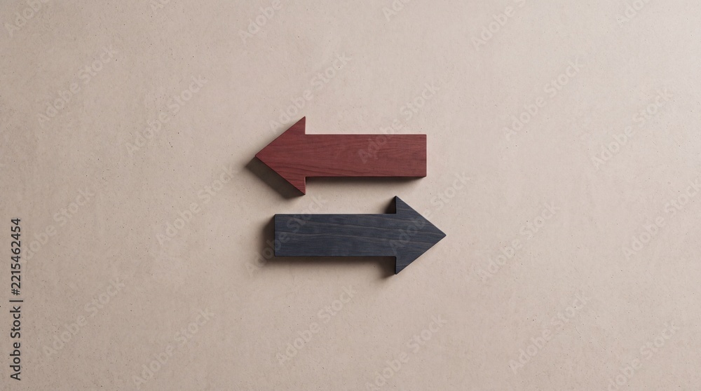Fototapeta premium Top down view of two wooden arrows pointing in opposite directions on a neutral background, representing choice, decision making, contrast, and alternative paths in business and life.