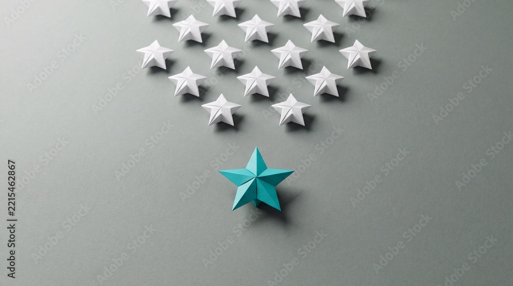 Fototapeta premium Conceptual Overhead Shot of a Unique Teal Blue Paper Origami Star Leading a Group of White Stars on a Grey Background, Representing Leadership, Individuality, Success, and Standing Out.