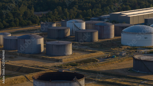 Aerial view of industrial storage tanks at a fuel terminal with large cylindrical containers and a white dome tank in Hunxe, North Rhine-Westphalia, Germany.