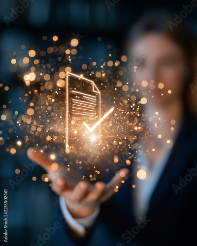 Digital Document Verification: A glowing digital document icon with a prominent checkmark floats above a woman's outstretched hand, surrounded by shimmering particles.