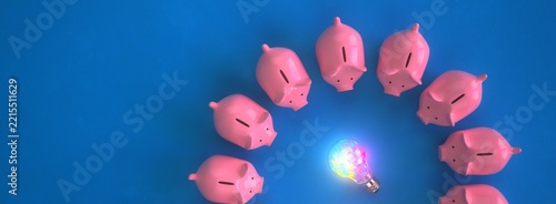 3d illustration. Creative Financial Idea with Piggy Banks and Glowing Light Bulb