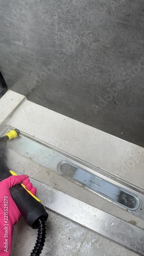 A detailed look at the cleaning process using a vaporizer on a surface with a leveling tool, showcasing the transformation from dirty to clean in two stages.