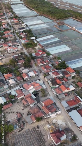 Aerial View of Coastal Village and Salt Evaporation Ponds at Afternoon 
