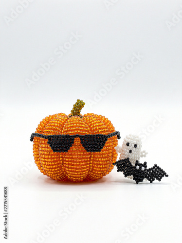 Beaded orange pumpkin wearing black sunglasses, cool attitude