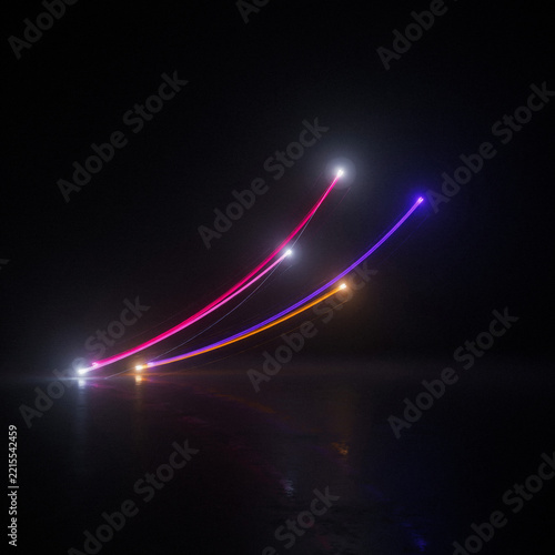 Three glowing light streaks curving upwards on a dark reflective floor with abstract movement reflection artistic background velocity creative fluidity technique photography composition