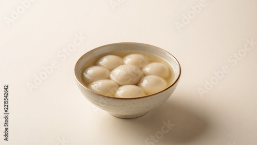 White glutinous rice balls tangyuan in sweet soup, ceramic bowl