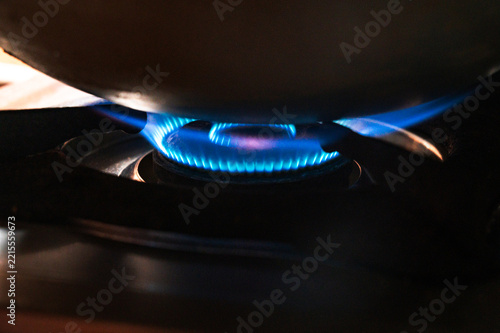 Sticker A woman uses a pressure cooker on a gas stove burner to quickly cook rice