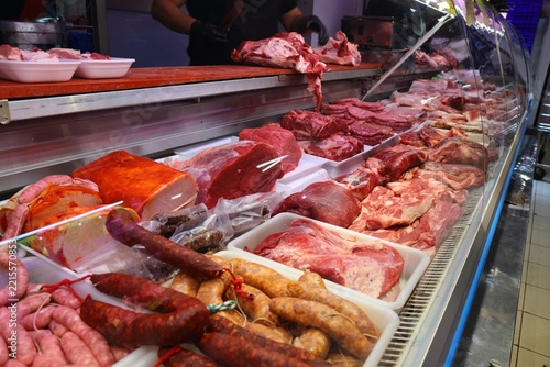 Butcher's shop fresh raw meat at local market hall Mercat Central in Alicante, Spain. Spanish food.