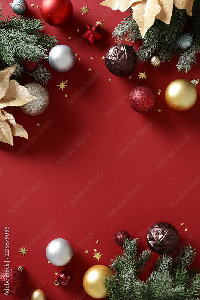 Fototapeta premium Christmas flat lay with red background and luxury ornaments