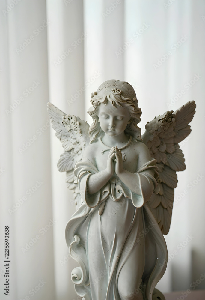 Fototapeta premium Spirituality and prayer concept, stone angel statue with folded hands for meditation, peace and religious devotion in a serene home interior setting