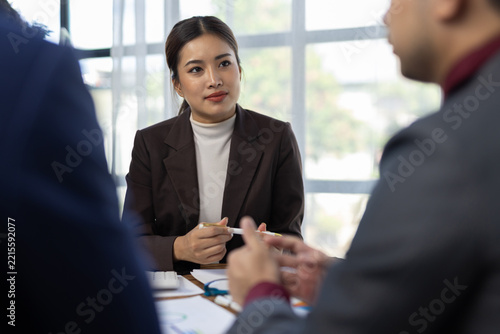 Business professionals discussing work during a corporate meeting. Business professionals collaborating and having a discussion in a corporate meeting, teamwork and strategic planning.