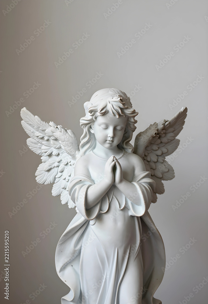 Fototapeta premium Spirituality and faith concept white marble angel statue with praying hands and wings religious peace and hope serene cherub sculpture for memorial