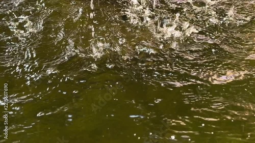 Heavy Splashing Drops on Green Water Surface Slow Motion 4K Video