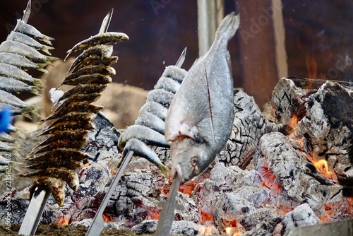 Grilled Fish on Skewers Over Open Fire