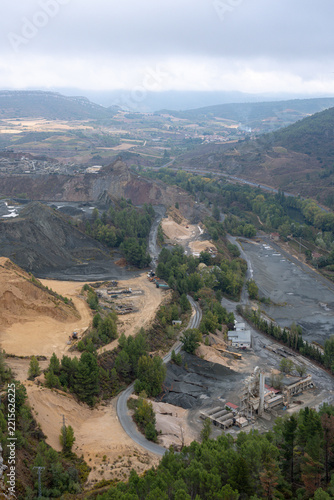 Aerial vertical view of open pit mine and aggregate quarry in mountain valley