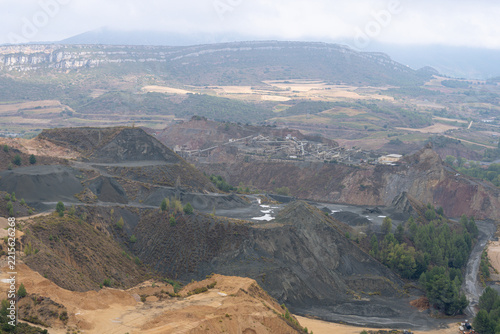Panoramic high angle view of open pit quarry and aggregate mining site in mountainous landscape