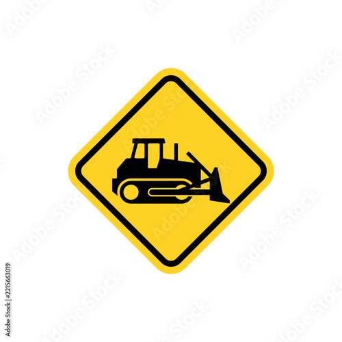 Yellow diamond warning sign with bulldozer icon indicating construction zone ahead.