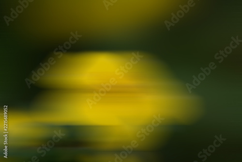 Blurred abstract background with warm yellow and green hues