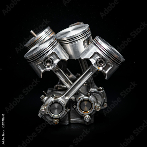 Close up of metal engine pistons and connecting rods isolated on a