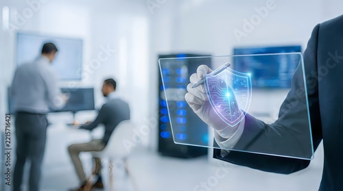 Cybersecurity professional using a digital pen to interact with a holographic shield interface in a modern server room office environment