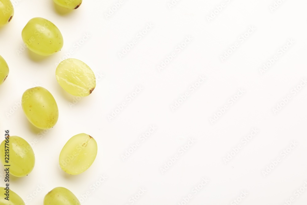 Fototapeta premium Fresh ripe grapes on white background, flat lay