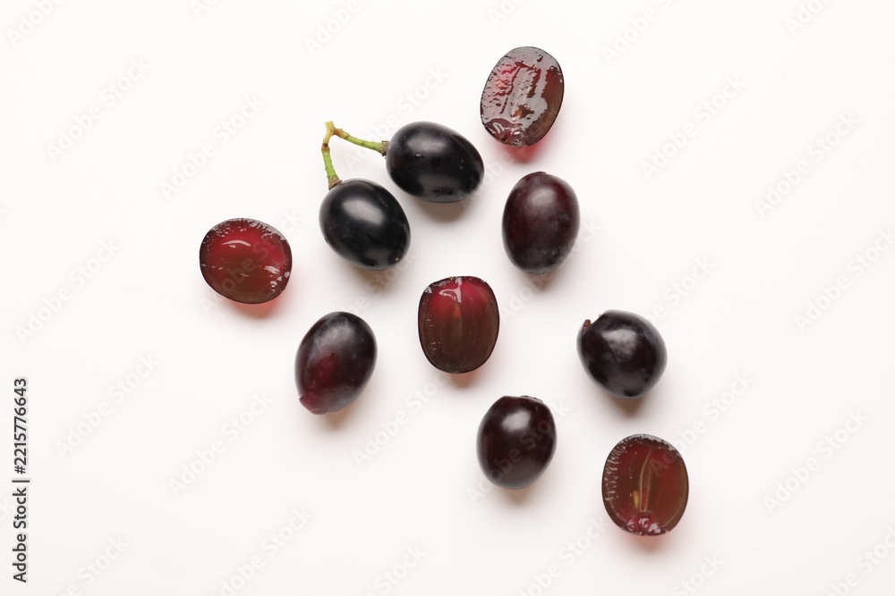 Fototapeta premium Fresh ripe grapes on white background, flat lay