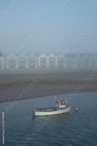 Boat on the river Axe in Devon on a foggy day