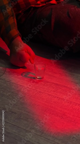 Hand reaching for a glass of alcohol