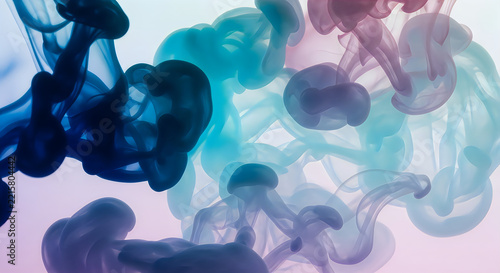 Abstract colorful ink clouds swirling in water