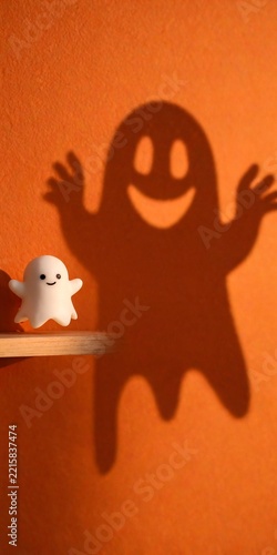Tiny Ghost Figure Casting an Oversized Smiling Shadow