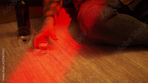 Hand reaching for a glass of alcohol