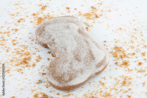 Christmas angel cookie with crumbs on white background