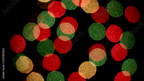 Festive red, green and gold blurred light circles on black