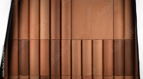 Vertical ribbed terracotta tiles arranged in a grid pattern