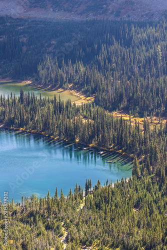Vertical image of hidden lake in glacier national park in fall season