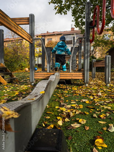 Toddler Practicing Independence During Outdoor Playground Play
