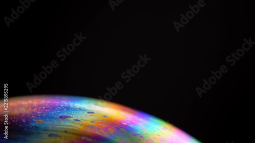 Rainbow multilayer film. Spherical abstraction of iridescent blue, yellow and red colors with soft focus. The natural environment.