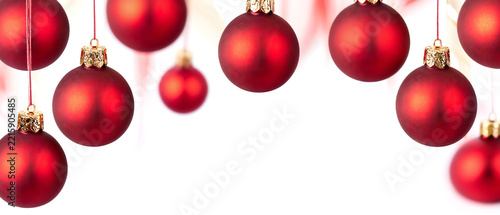 Set of hanging matte red Christmas baubles isolated on a white background with copy space for holiday greeting card