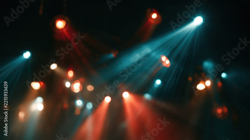 Stage spotlights colorful light beams concert bokeh dark background red teal nightclub party show entertainment event music