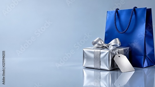 Metallic Blue Shopping Bag and Silver Gift Box on Icy Blue Background