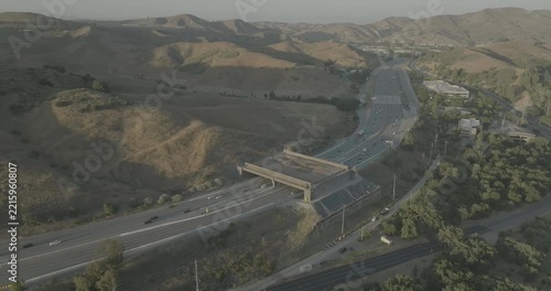 Aerial view of freeway with overpass bridge in hazy hills