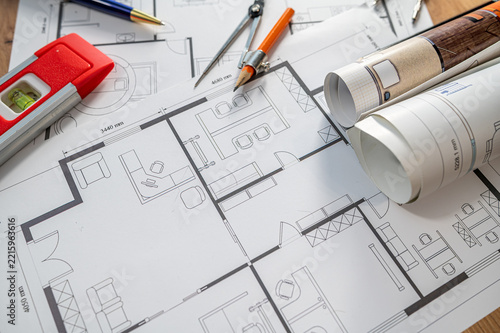 House Blueprint Project Layout with Construction Spirit Level and Drafting Compasses on Wood Desk