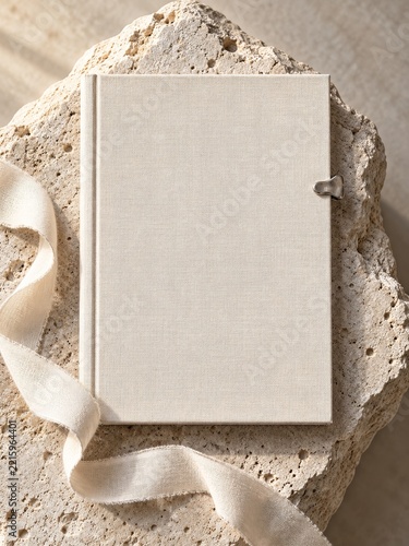 Blank Cream Linen Book on Porous Stone with Ribbon and Silver Clip