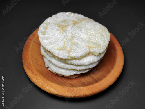 Palembang Kemplang Crackers Served on Wooden Plate and Dark Background.