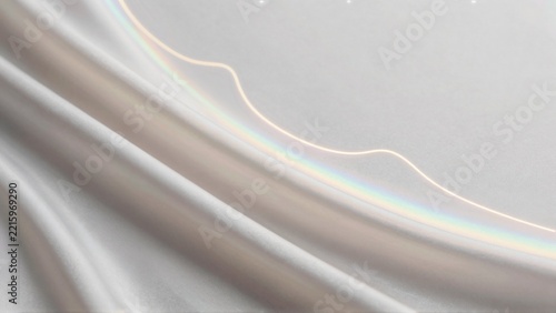 close white fabric curved line running diagonally across line appears multiple colors including blue green yellow pink colors arranged gradient pattern creating rainbow like effect fabric has smooth