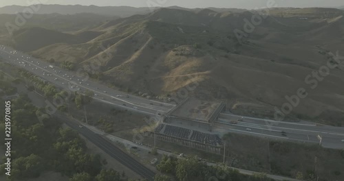 Aerial view of freeway with overpass bridge in hazy hills