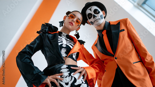 Stylish couple in Halloween costumes posing with a playful attitude and vibrant colors.